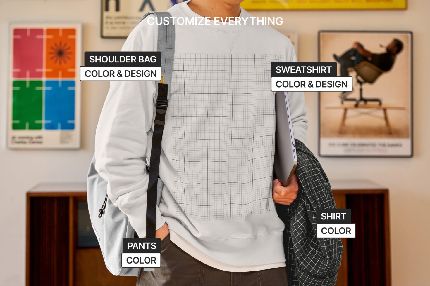 Person wearing gray sweatshirt, white shirt, dark pants, holding laptop with labeled customizable pieces