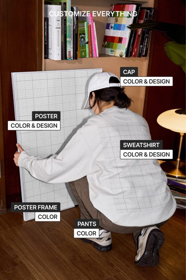 Person crouching holding poster showing multiple customizable apparel mockup items