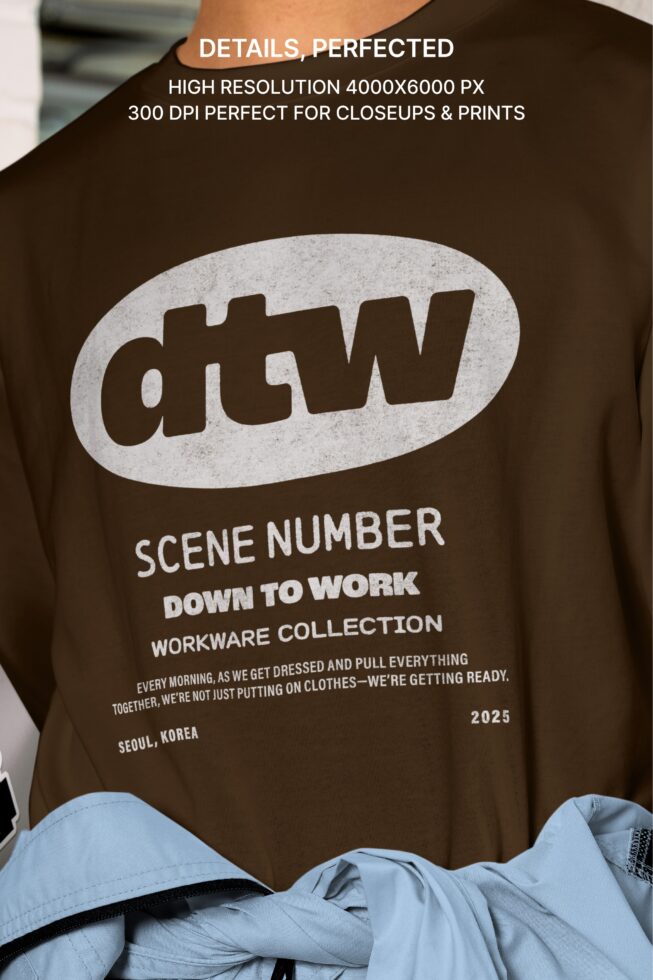 Brown tee with large dtw logo, scene number text, worn with light blue jacket