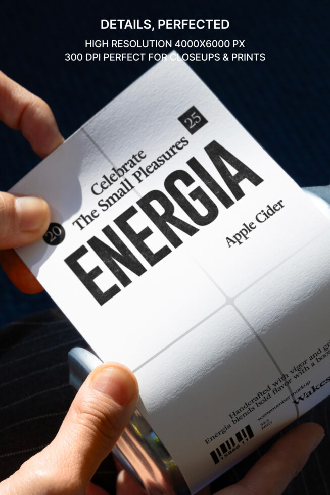 Close up of white can label showing ENERGIA text being held at angle against dark backdrop