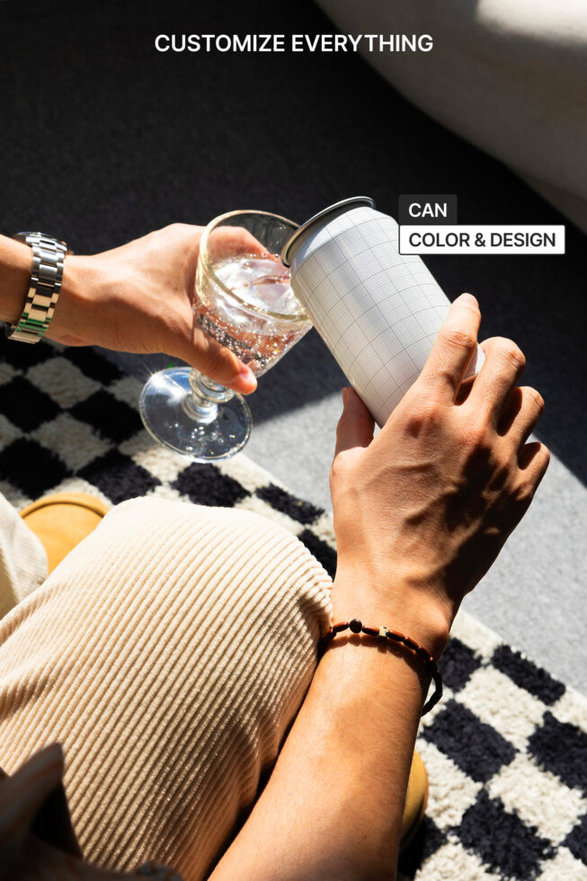 Hands holding glass, can mockup showing customizable grid overlay