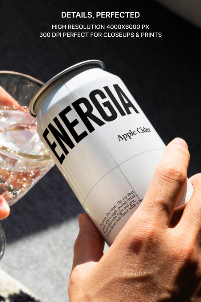 Close up of white Energia can being held with sparkling drink in glass