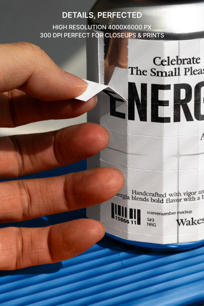 Hand peeling label off white beverage can showing gridded label design