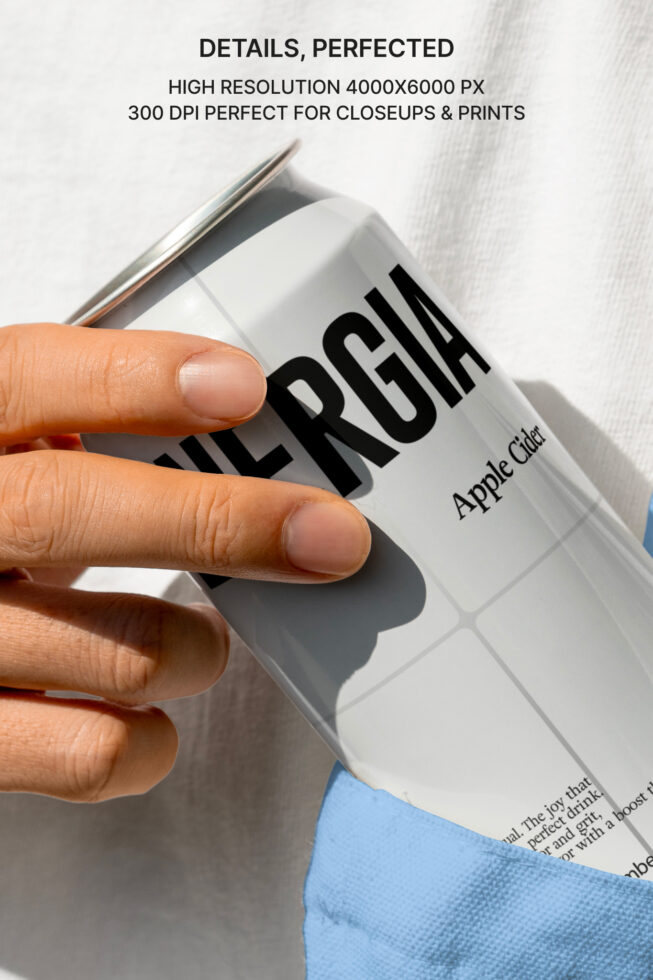 Close-up of hand holding white can mockup showing print detail
