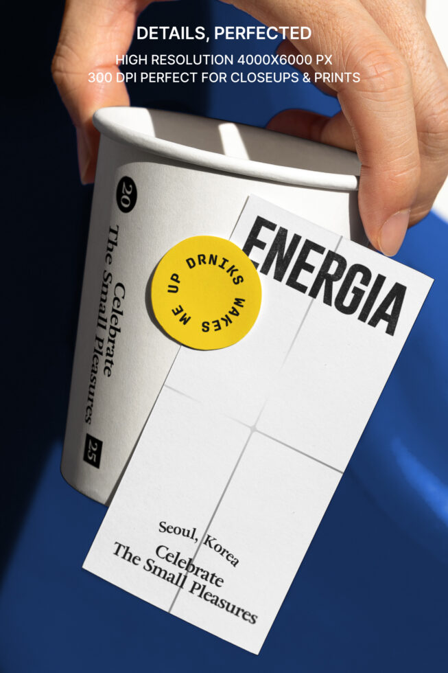 Hand holding takeout cup with yellow circular sticker next to blue product box