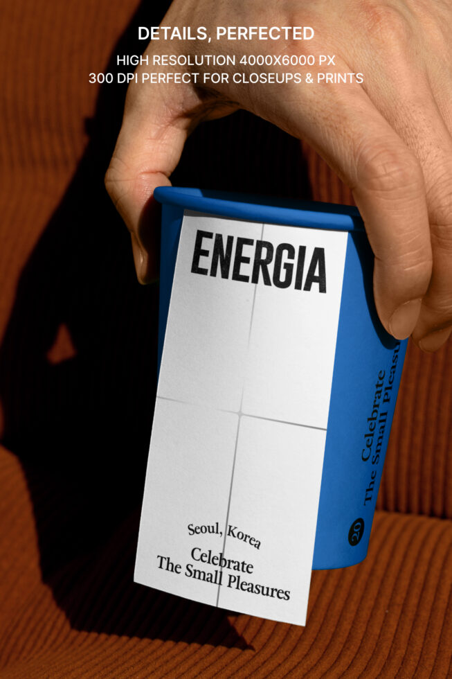 Hand holding blue paper box with white label showing ENERGIA text closeup