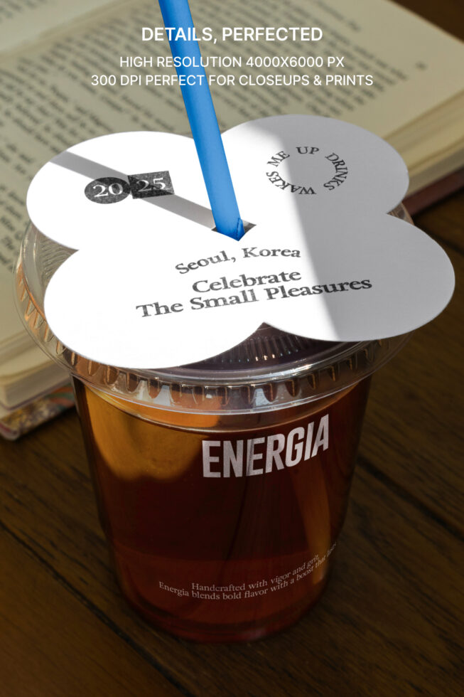 Drink cup mockup with cloud-shaped die-cut lid, blue straw on open book