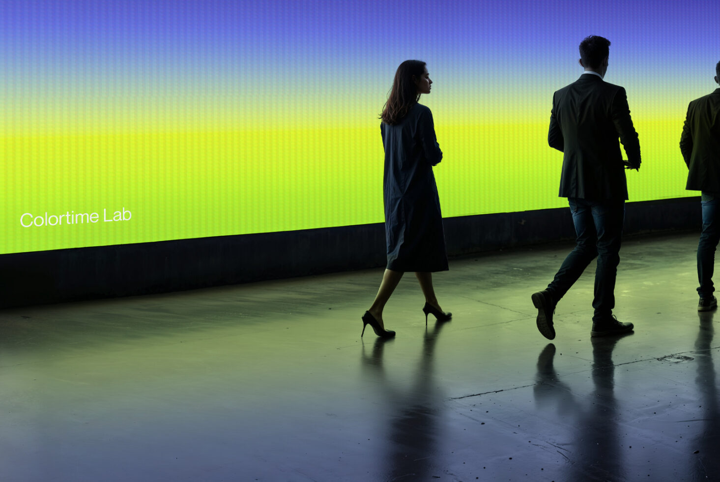 People walking in front of bright gradient display with Colortime Lab branding