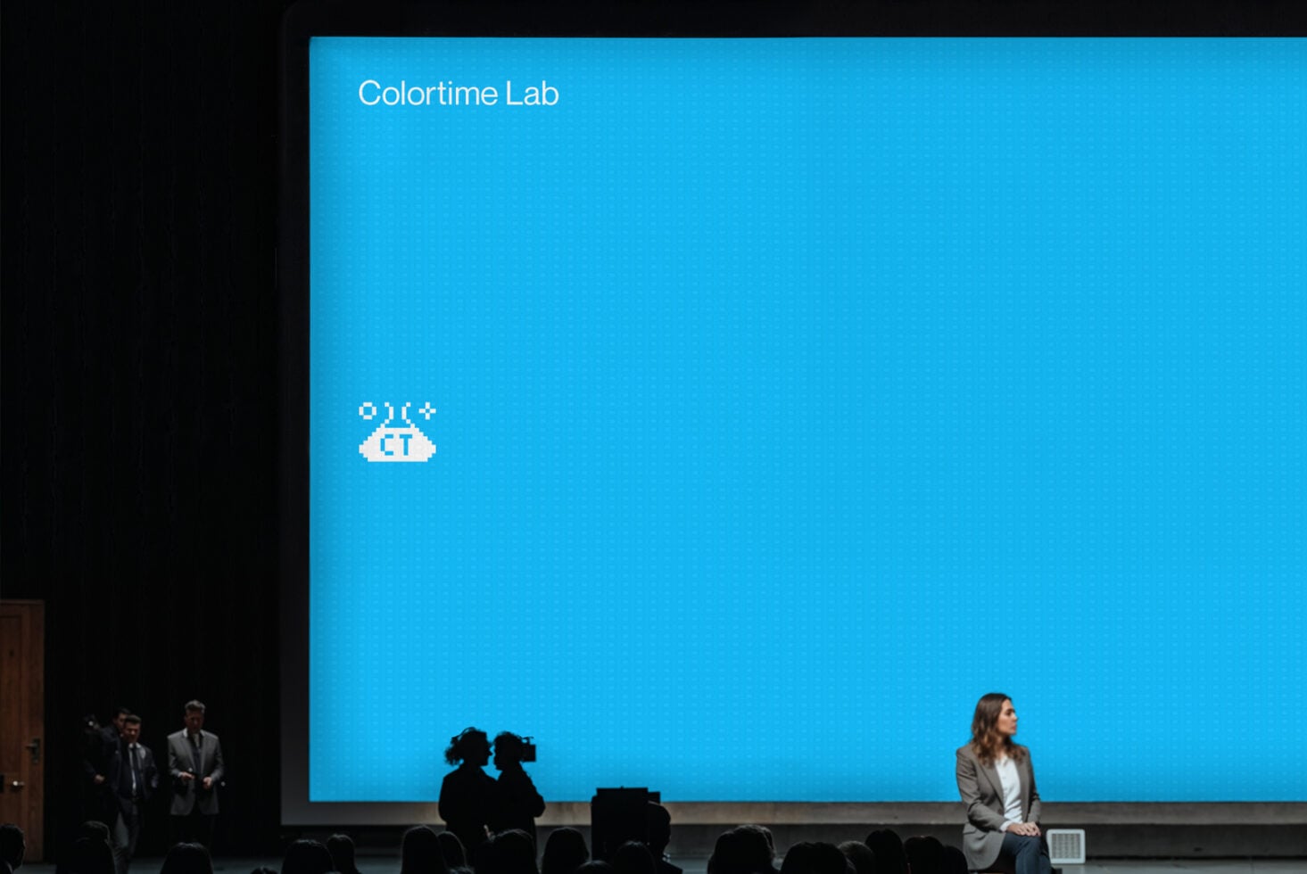 Large bright blue stage screen displaying Colortime Lab branding with pixel logo