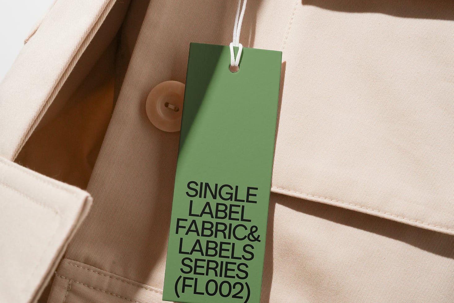 Green hang tag with black text on natural tan fabric with buttons