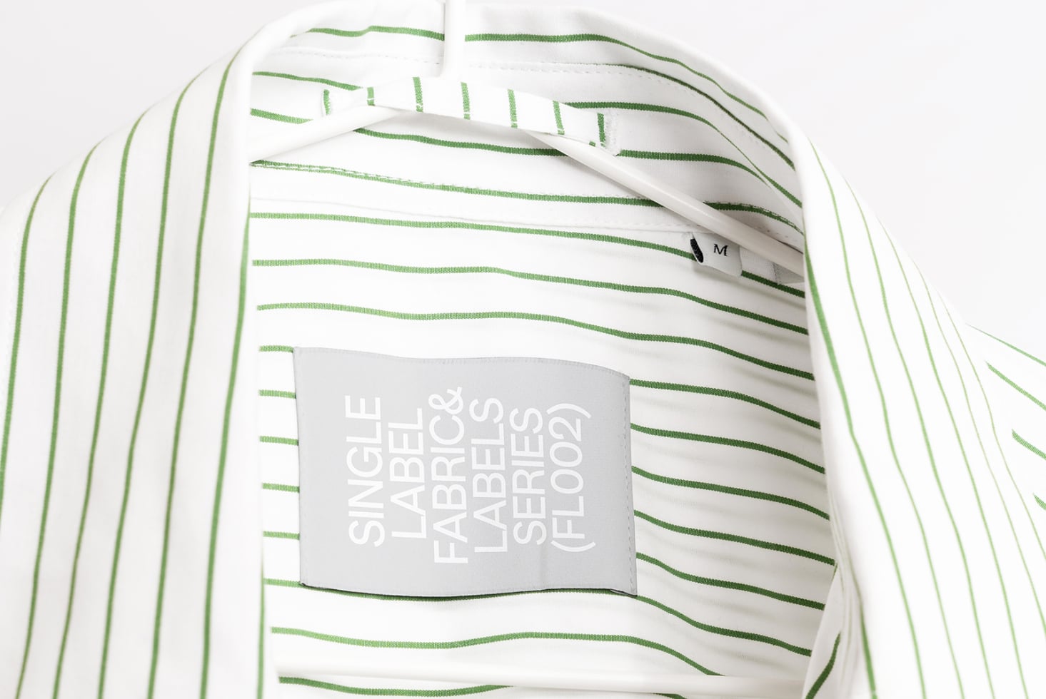 Striped white shirt with green horizontal lines showing gray hang tag mockup