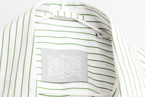 Striped white shirt with green horizontal lines showing gray hang tag mockup