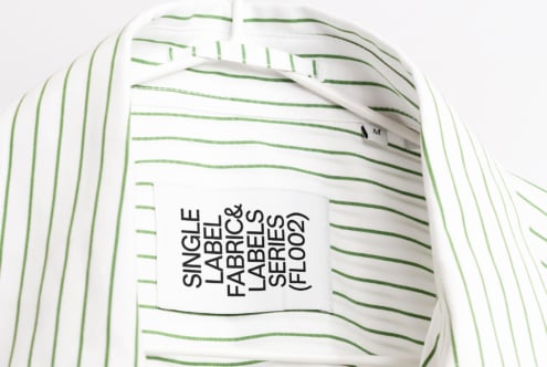 Striped white shirt with green lines displaying black text hang tag mockup