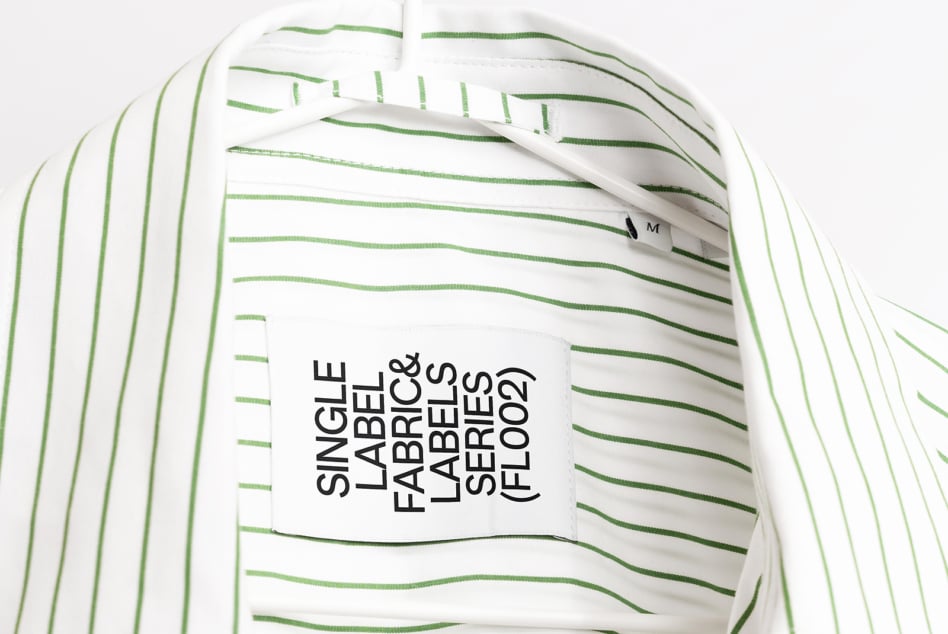 Striped white shirt with green lines displaying black text hang tag mockup
