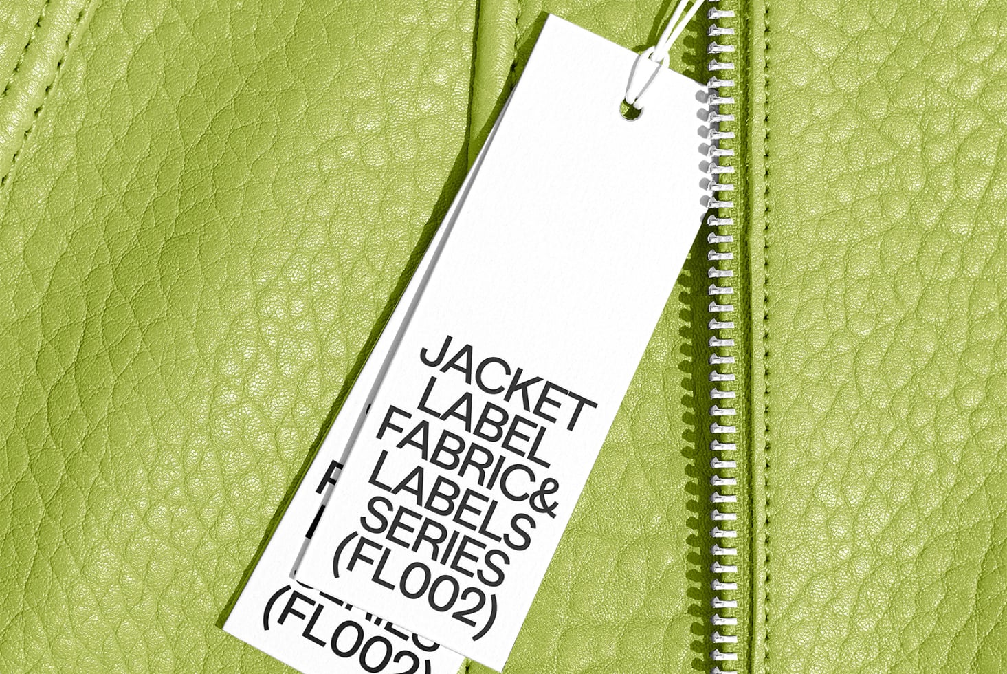 White hang tag on lime green textured leather jacket with spiral notebook