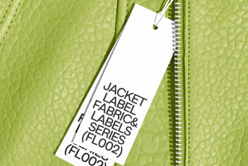 White hang tag on lime green textured leather jacket with spiral notebook