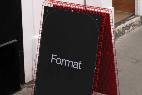 Red plastic A-frame sidewalk sign with black display surface showing Format text