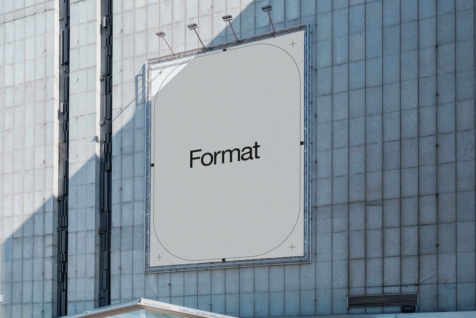 Light billboard on modern building facade with Format text centered in white