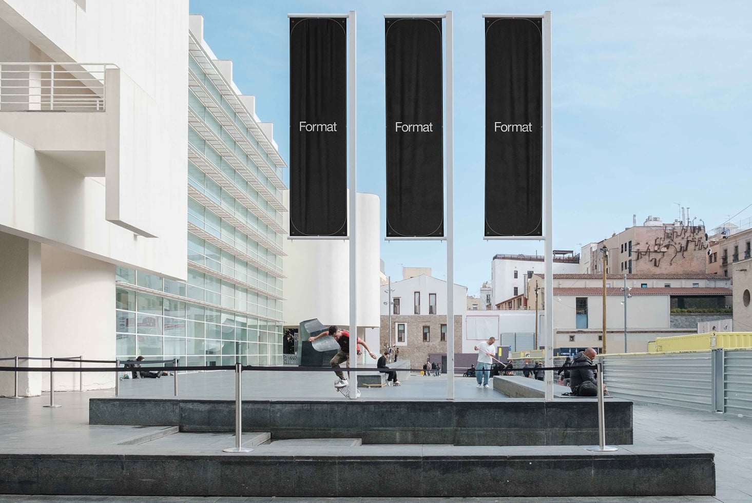 Three tall vertical banners on building facade overlooking plaza, dark fabric