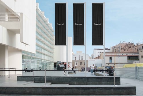 Three tall vertical banners on building facade overlooking plaza, dark fabric