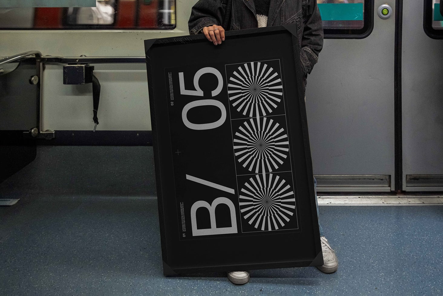 Person holding dark poster mockup inside transit vehicle