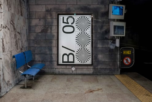 Light poster mockup on concrete wall next to blue seating