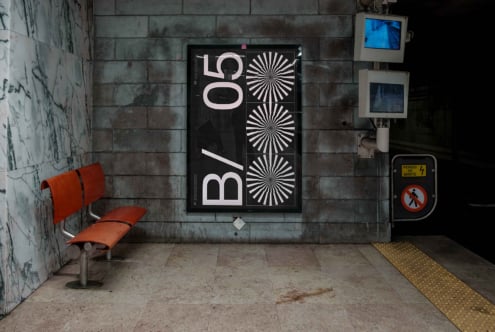 Dark poster mockup on grunge tile wall with orange bench visible