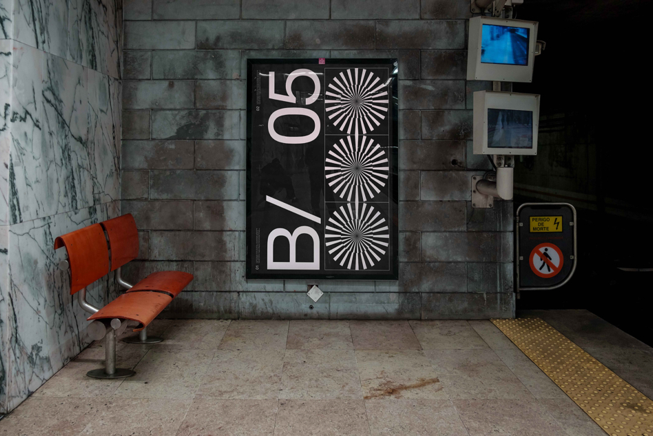 Dark poster mockup on grunge tile wall with orange bench visible