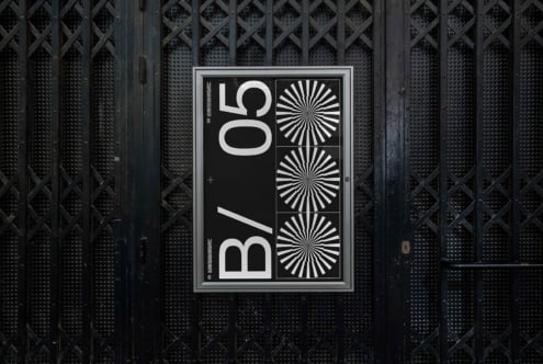 Dark poster mockup displayed on industrial metal mesh wall surface