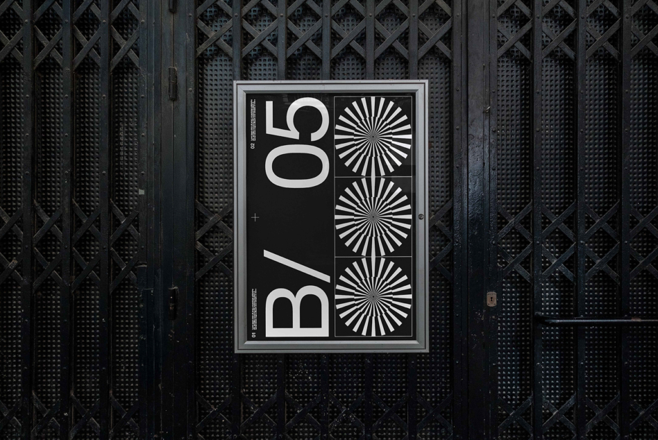 Dark poster mockup displayed on industrial metal mesh wall surface