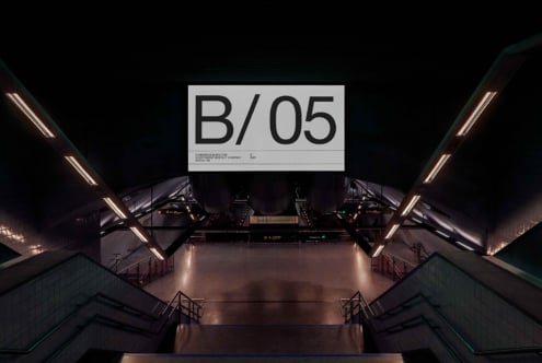 Overhead billboard mockup in futuristic transit hub showing B/05 with neon accent lighting