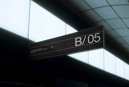 Black horizontal suspended signage with B/05 in modern minimalist ceiling interior