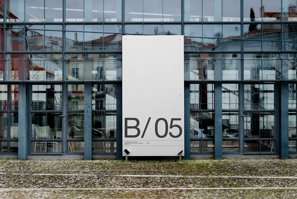 White vertical banner mockup showing B/05 on contemporary glass building storefront