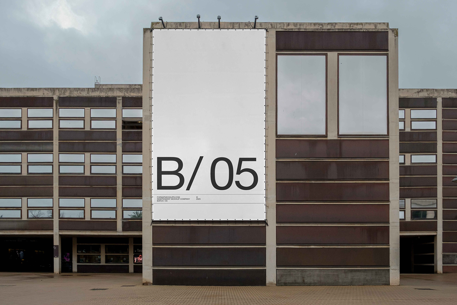 Large white billboard mockup showing B/05 on brutalist concrete building facade