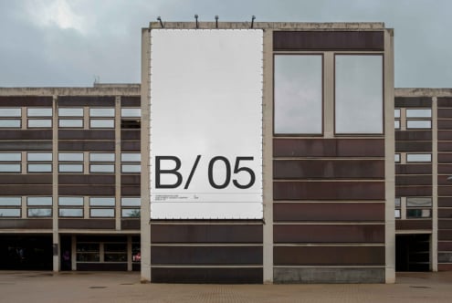 Large white billboard mockup showing B/05 on brutalist concrete building facade