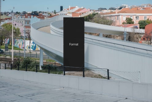 Tall rounded vertical sign mockup with Format text in modern plaza setting