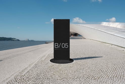 Black vertical sign mockup on waterfront promenade overlooking harbor