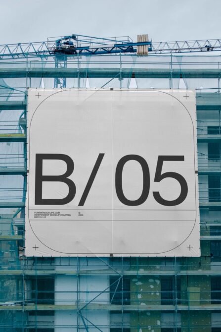 Massive construction banner hung on scaffolding with bold sans serif type