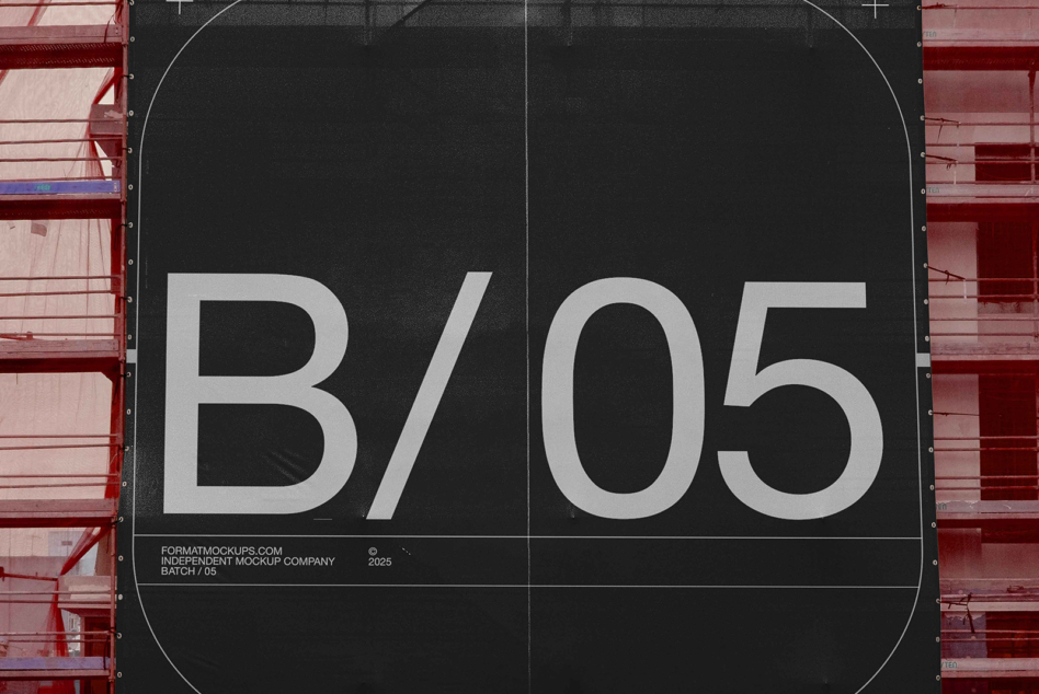 Black fabric banner on red steel framework showing white sans serif lettering
