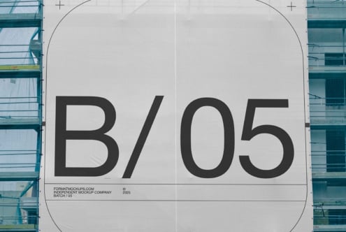 Close-up of industrial building wrap displaying large letterforms on white