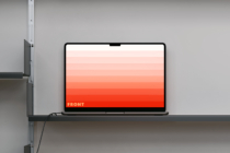 Laptop on shelf showing coral to red gradient display with text overlay