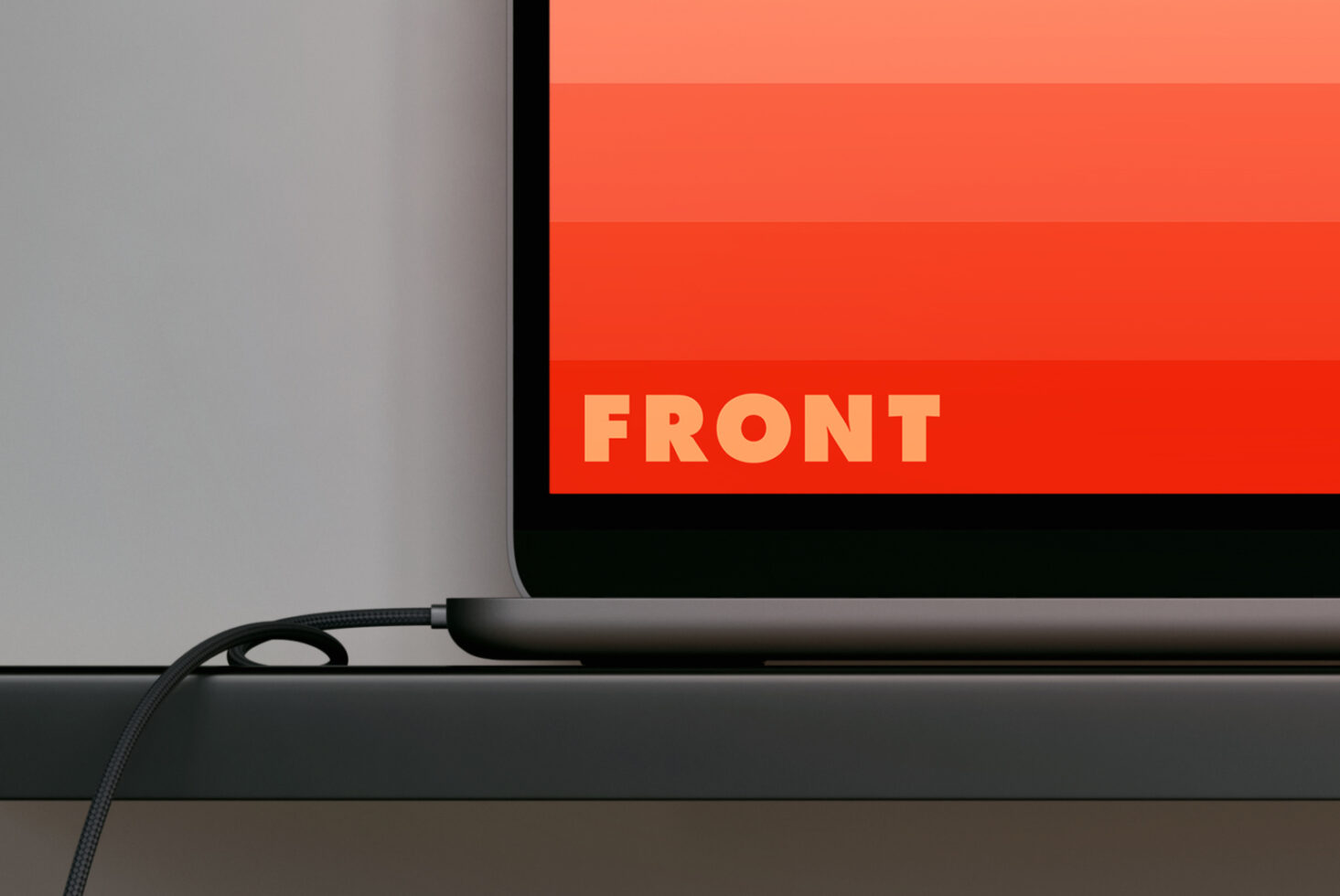 Tablet on desk displaying red gradient screen with bold yellow text