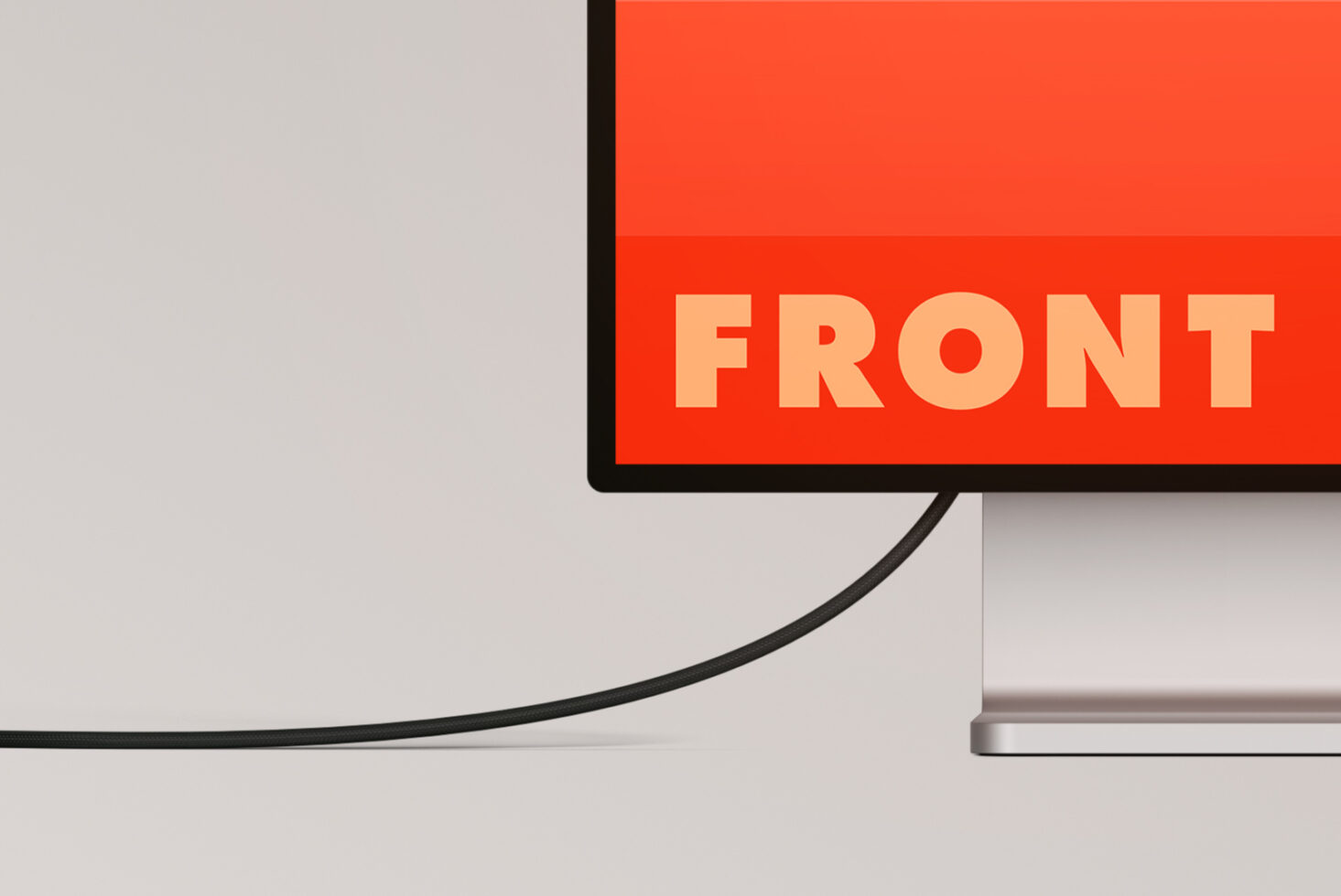 Desktop monitor displaying bold peach text reading FRONT on red background