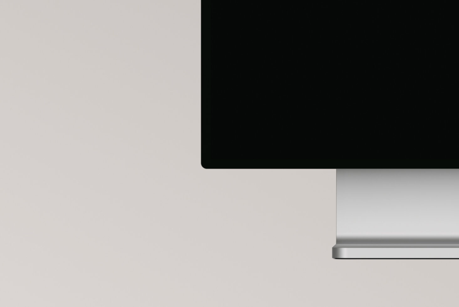 Modern desktop computer with black screen mounted on white surface