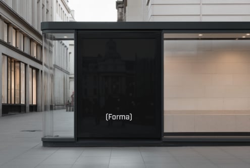 Wide storefront display with blank black screen on downtown street corner
