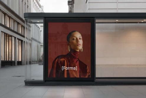 Wide storefront display with woman in burgundy satin turtleneck on red background