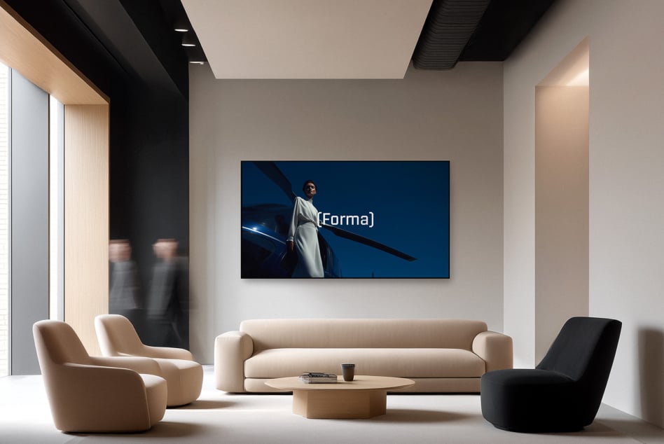 Contemporary space with wall-mounted screen showing figure in white clothing blue setting