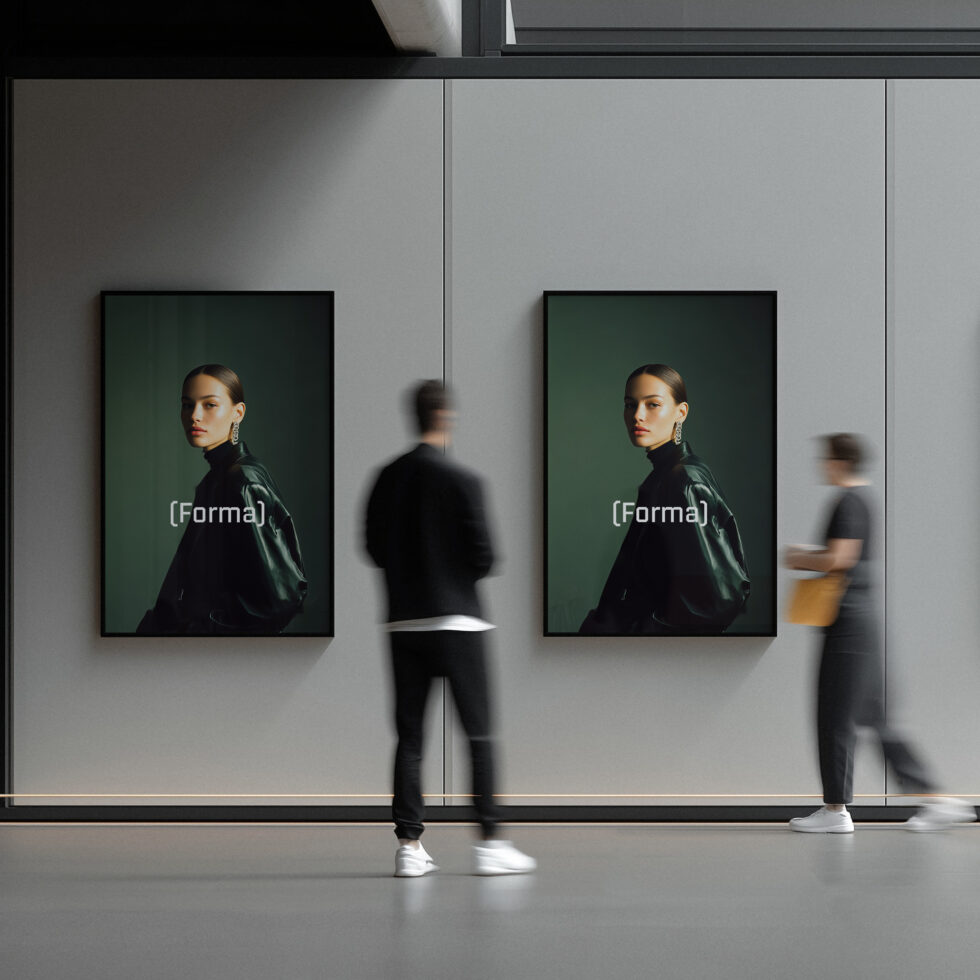Two portrait posters in black frames on white wall with people walking nearby