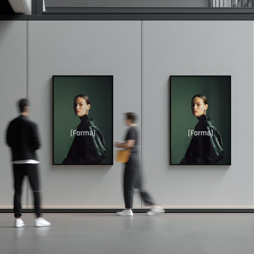 Two framed portrait posters on gallery wall with blurred people walking by