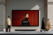 Woman in black turtleneck against red background on street-level gallery screen